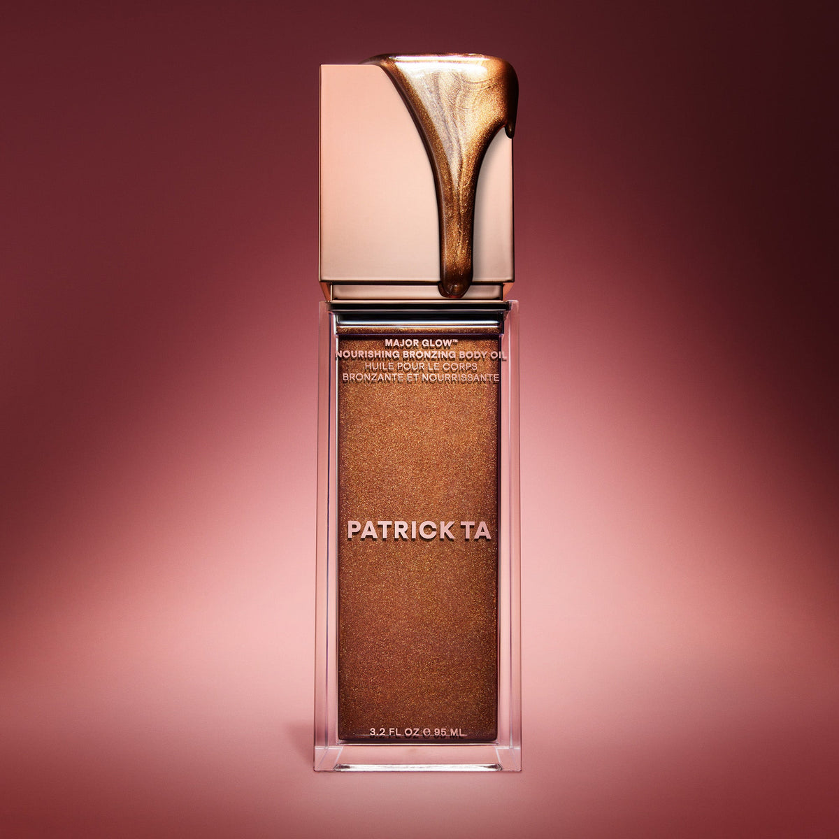 Patrick Ta Major Glow Nourishing Bronzing Body Oil - butelka ze złocistym olejkiem spływającym po zakrętce | Ellemania