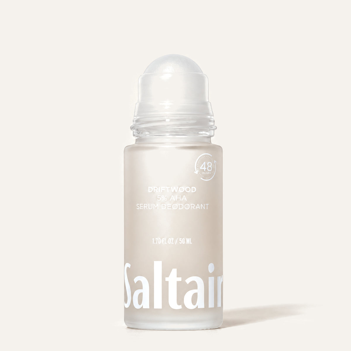 Saltair 5% AHA Serum Deodorant Driftwood 50 ml - frosted bottle with the roller ball uncapped on a beige background | Ellemania