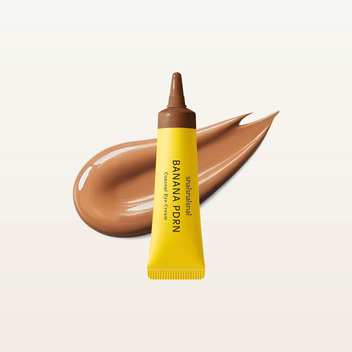 Shaishaishai Banana PDRN Conceal Eye Cream, odcień Toffee - żółta tuba z brązową końcówką i smuga brązowego kremu | Ellemania