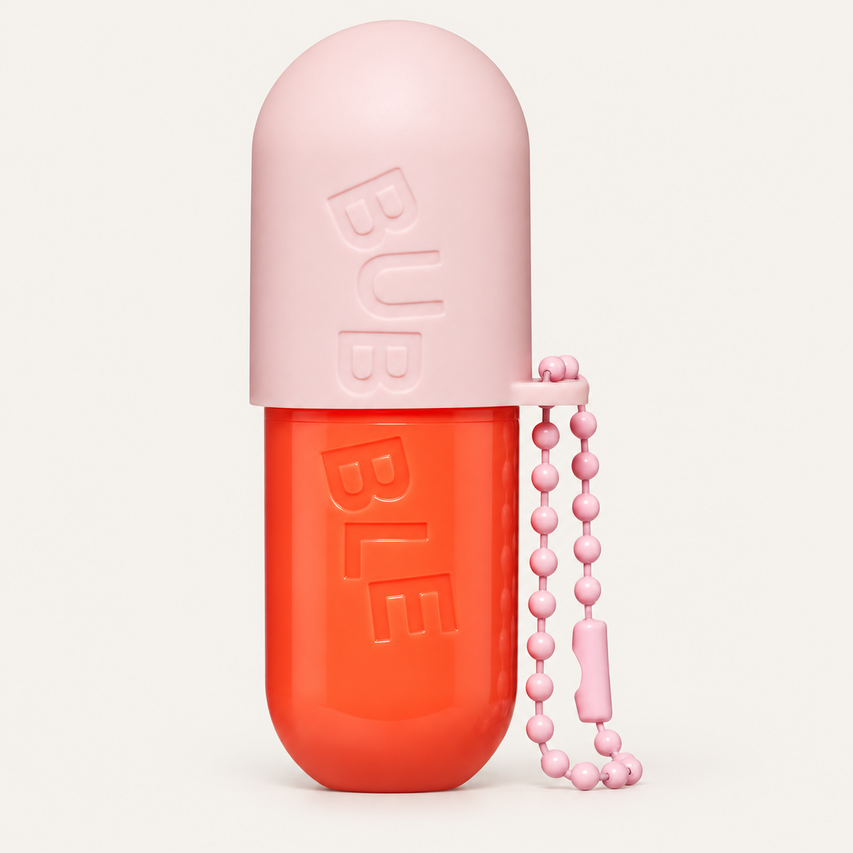 Bubble Tell All Lip Balm 4,4 g, pink and orange capsule-shaped container with a chain | Ellemania