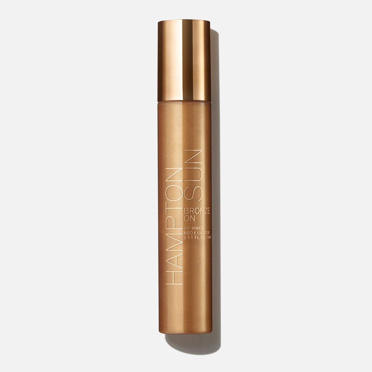Hampton Sun Bronze On Shimmer Body Luster 105 ml, butelka z metalicznym złotym wieczkiem z przodu | Ellemania
