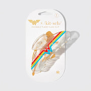 Przezroczysta spinka do włosów Kitsch x Wonder Woman z kolorowym emblematem W na opakowaniu ellemania