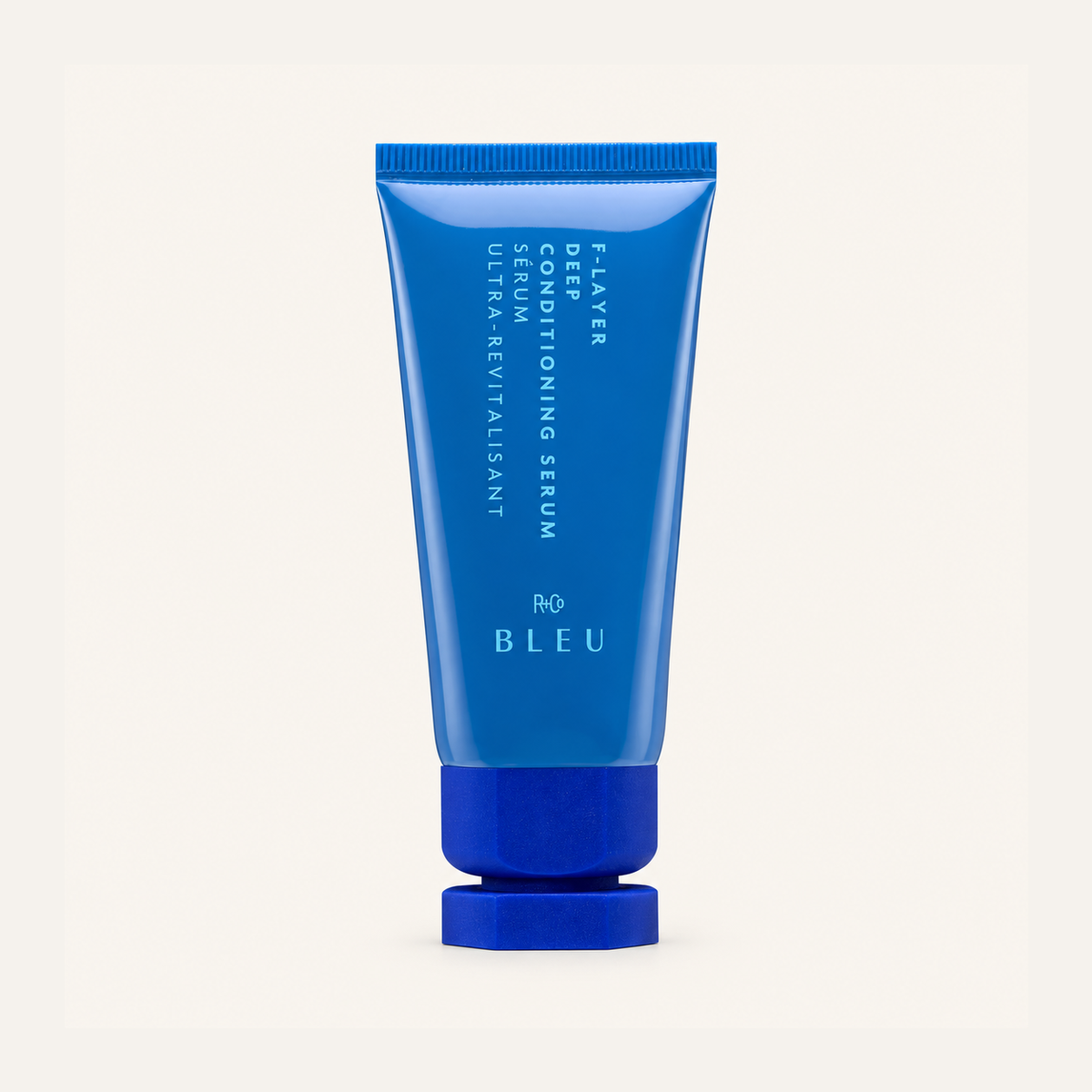 R+Co Bleu F-Layer Deep Conditioning Serum 124 ml, blue tube with a navy cap, front view | Ellemania