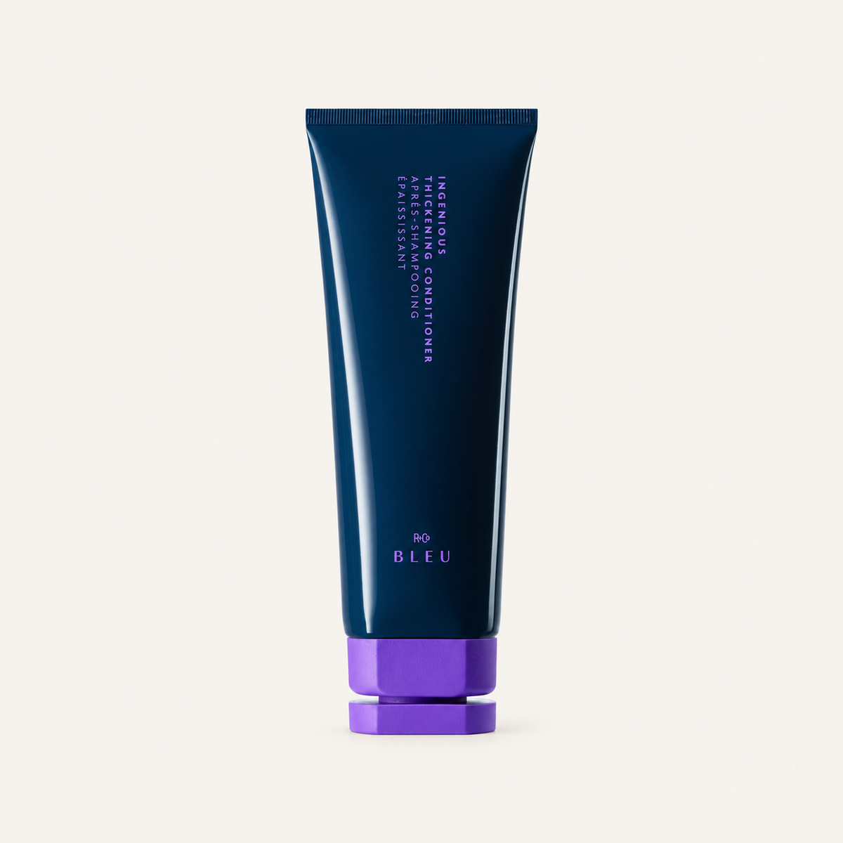 R+Co Bleu Ingenious Thickening Conditioner 201 ml, navy tube with a purple cap, front view | Ellemania