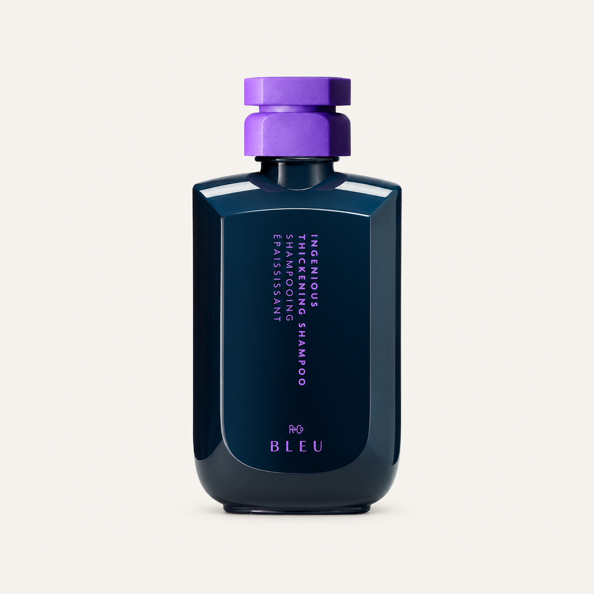 R+Co Bleu Ingenious Thickening Shampoo 251 ml, navy bottle with a purple cap, front view | Ellemania