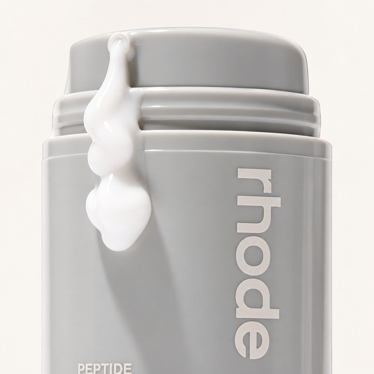 Rhode Skin Peptide Glazing Fluid 50 ml, szara butelka z kroplą płynu na korku | Ellemania