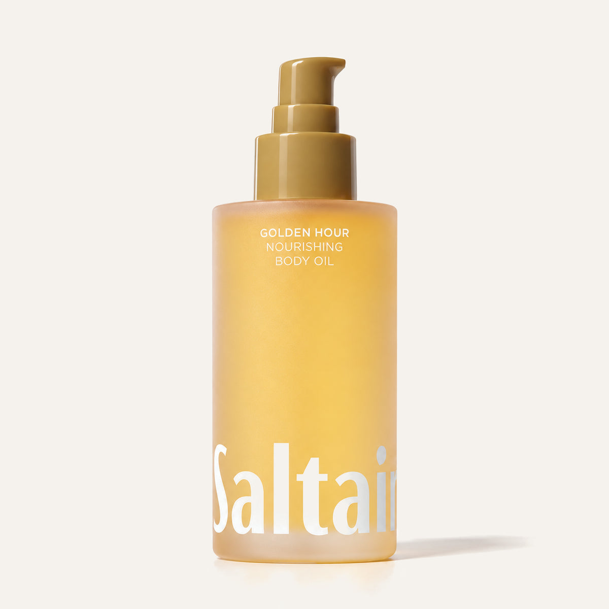 Saltair Golden Hour Nourishing Body Oil - amber frosted bottle with an olive pump on a beige background | Ellemania