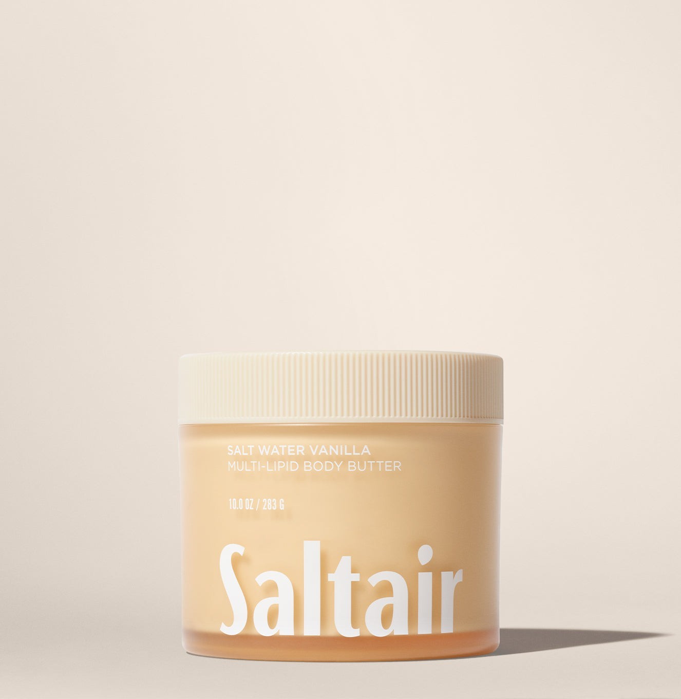 Słoiczek masła do ciała Saltair Multi-Lipid Body Butter w zapachu Salt Water Vanilla od ellemania na beżowym tle.