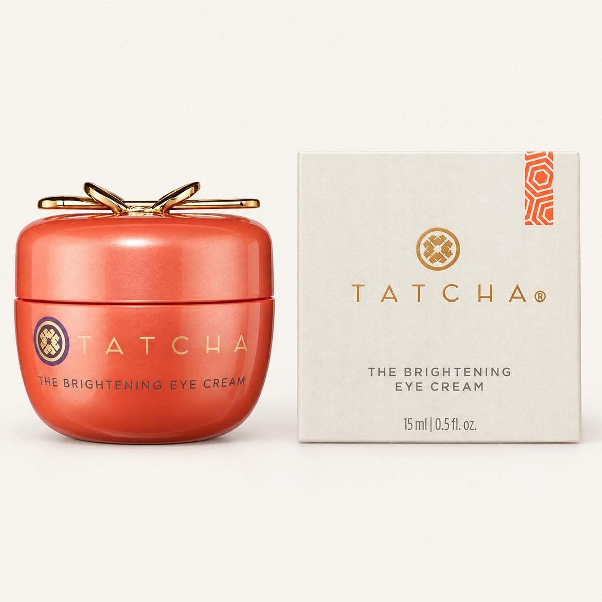 Tatcha The Brightening Eye Cream 15 ml, słoiczek w pomarańczowej obudowie z pudełkiem obok | Ellemania