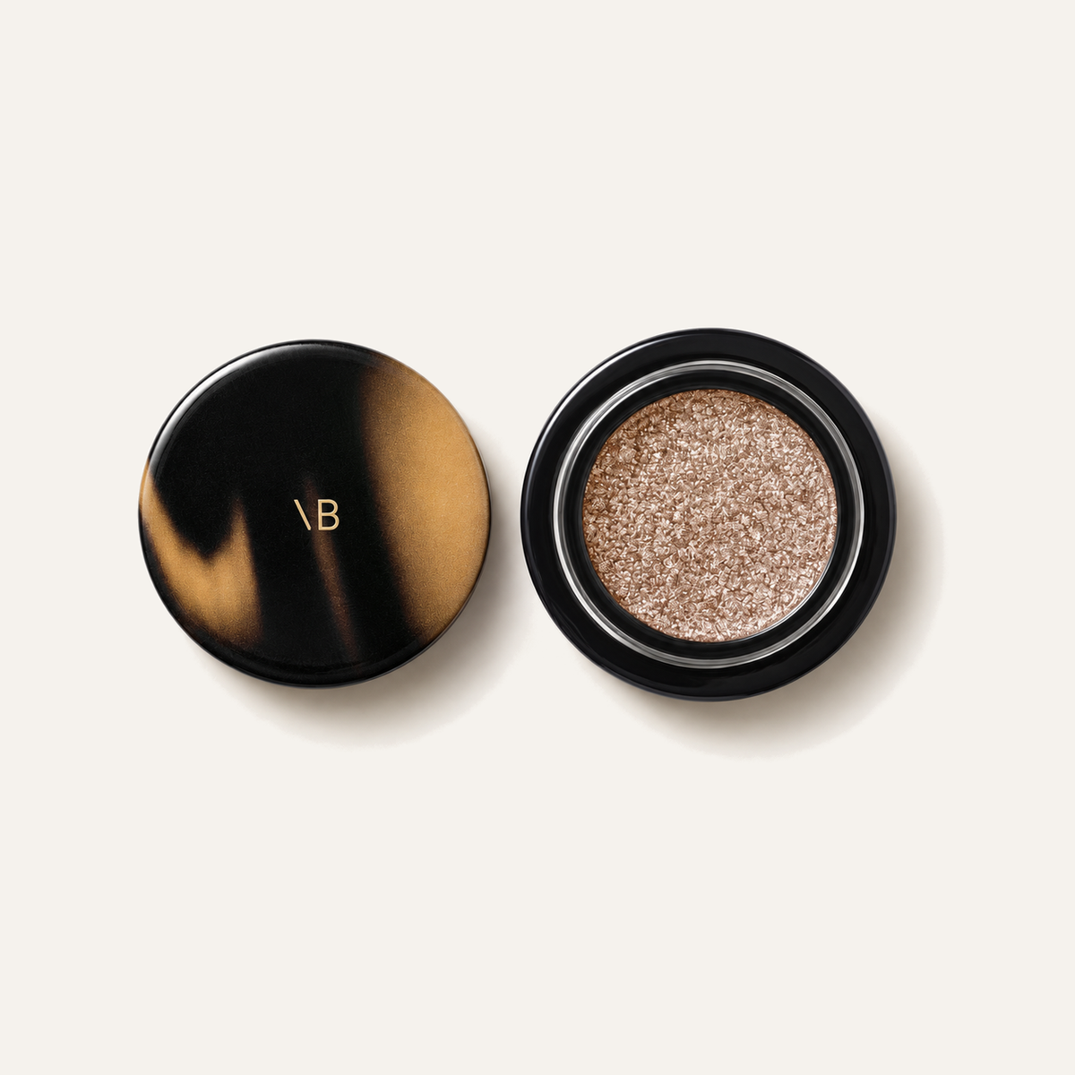 Victoria Beckham Beauty Lid Lustre, open tortoiseshell compact with glitter eyeshadow, viewed from above | Ellemania