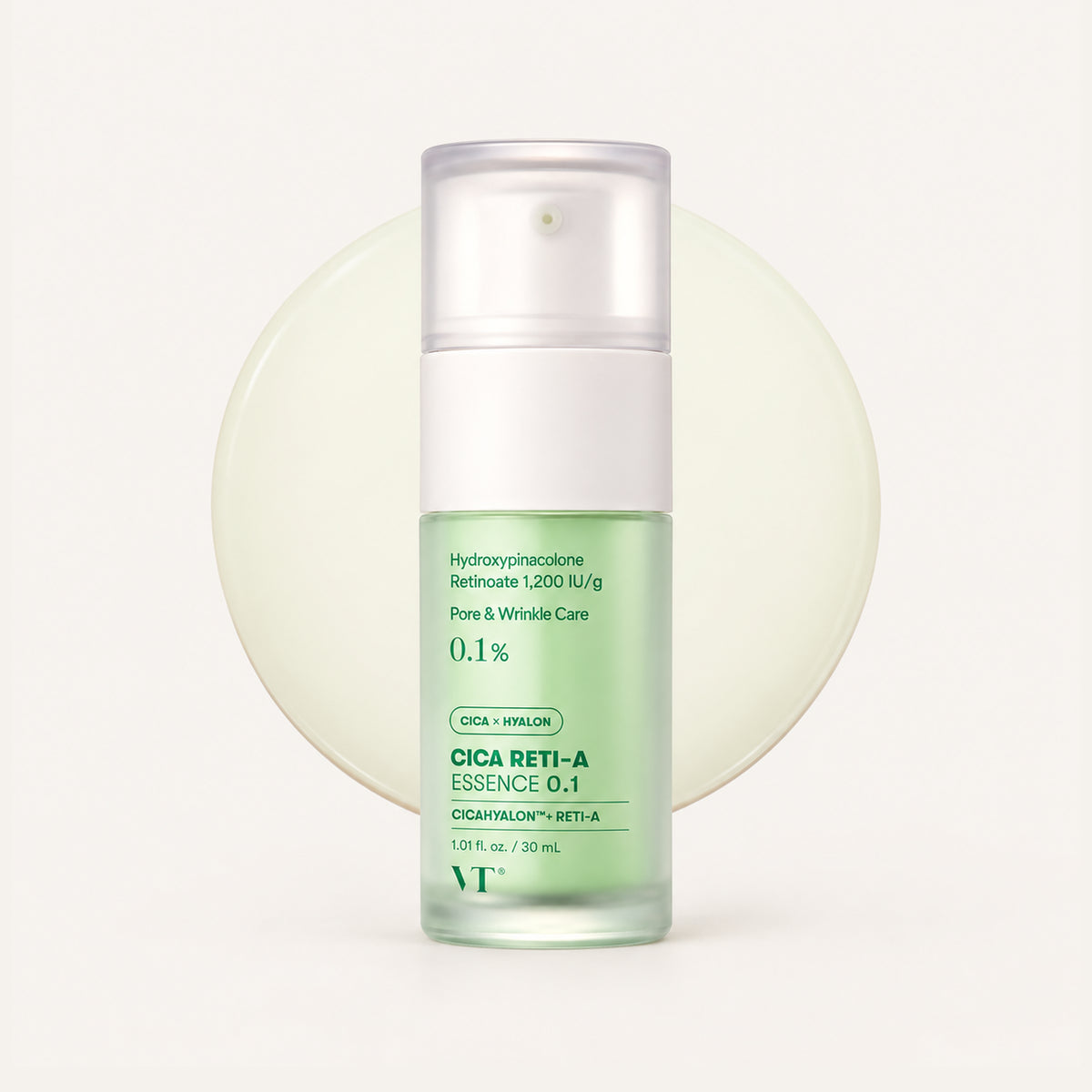 VT Cosmetics Cica Reti-A Essence 0.1% - pale green pump bottle with Cica Reti-A Essence 0.1 lettering, set on a cream circle, white background | Ellemania