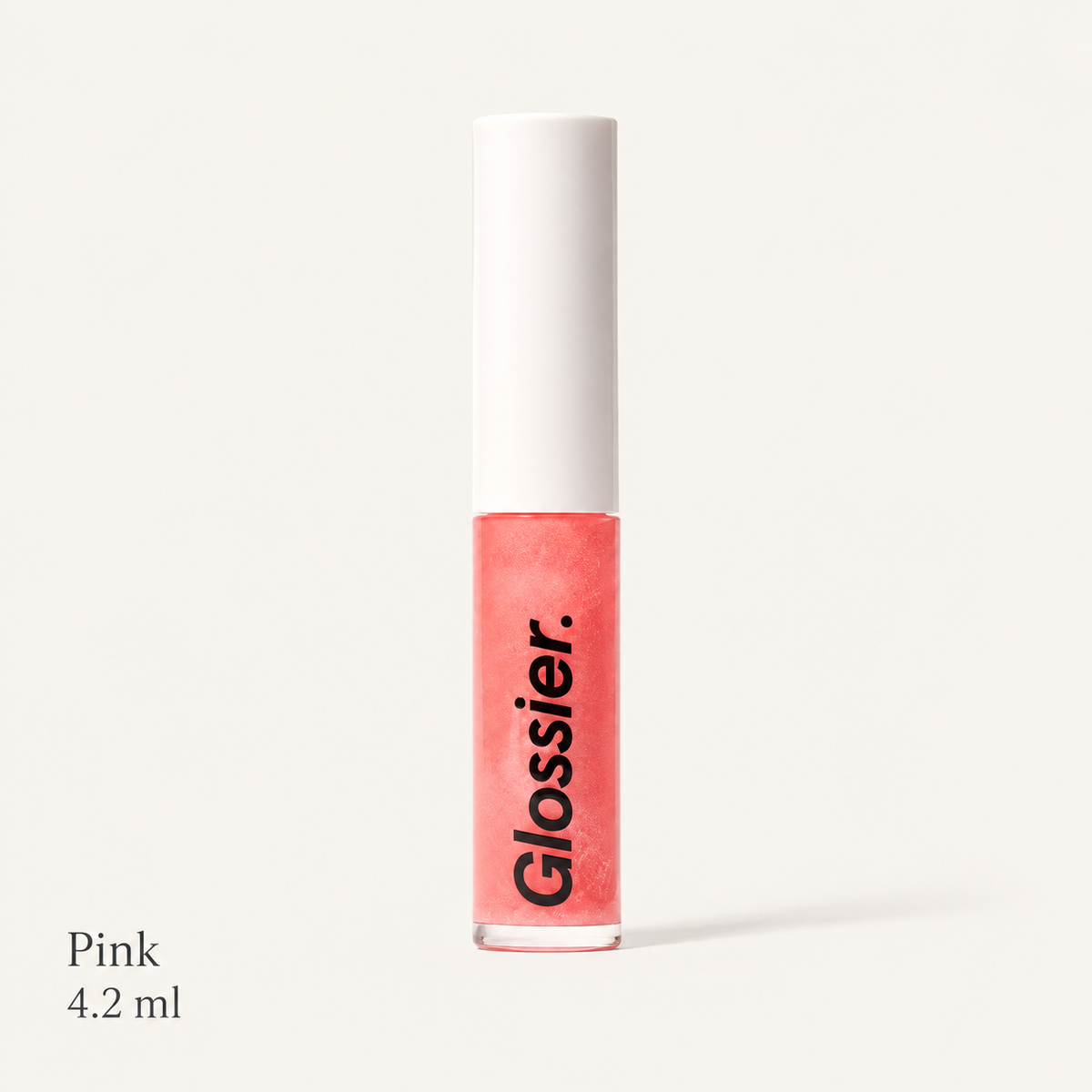 Glossier Lip Gloss Pink Rose - błyszczyk do ust w przezroczystej tubce z koralowo-różową formułą, białą nakrętką i czarnym napisem Glossier, podpis Pink 4.2 ml, na jasnym tle | Ellemania