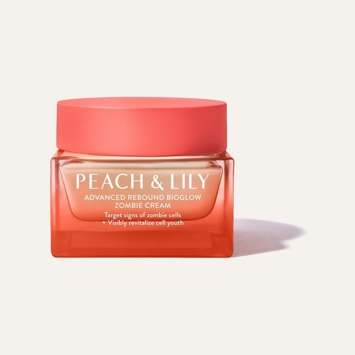 Peach & Lily Advanced Rebound Bioglow Zombie Cream - koralowy szklany słoik z koralową nakrętką 50 ml na jasnym tle | Ellemania